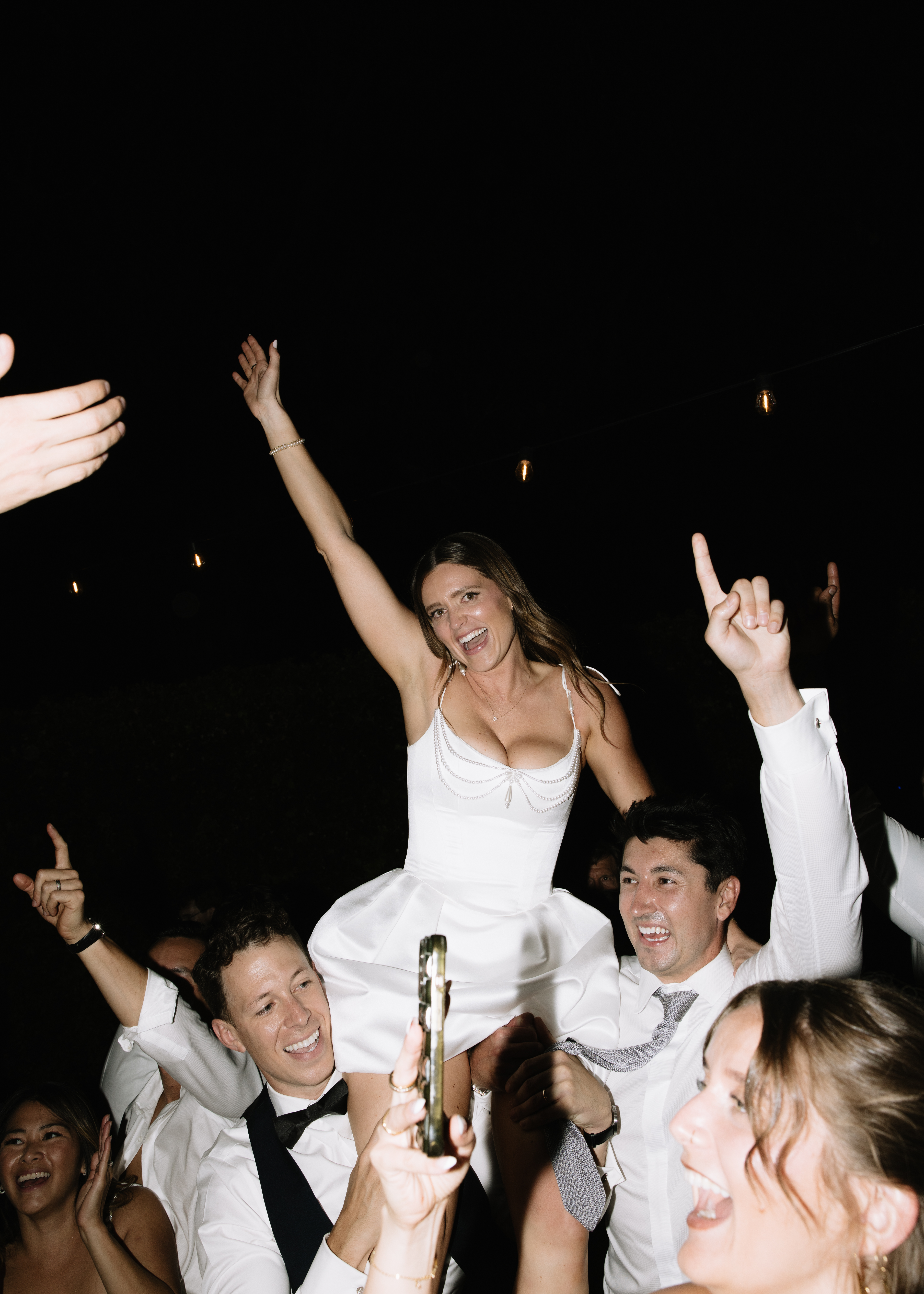Bride lifted on guests’ shoulders during last dance at Annadel Estate Winery wedding reception.